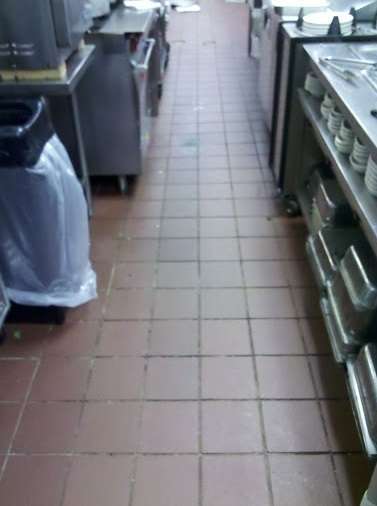 Commercial kitchen before regrouting looking like dark grout lines
