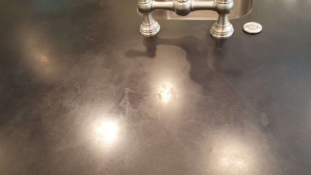 Black granite countertop with smeary marks